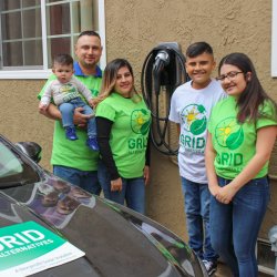 Figuroa family (parents and four kids) with their new electric vehicle