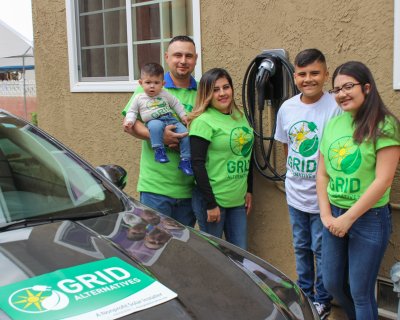 Figuroa family (parents and four kids) with their new electric vehicle
