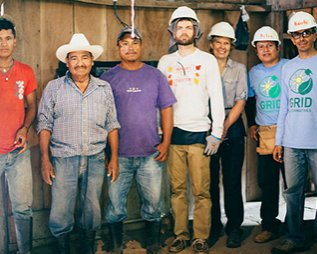 People in hard hats smile on construction site in Nicaragua