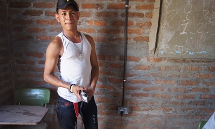 Young Nicaraguan barber in his shop