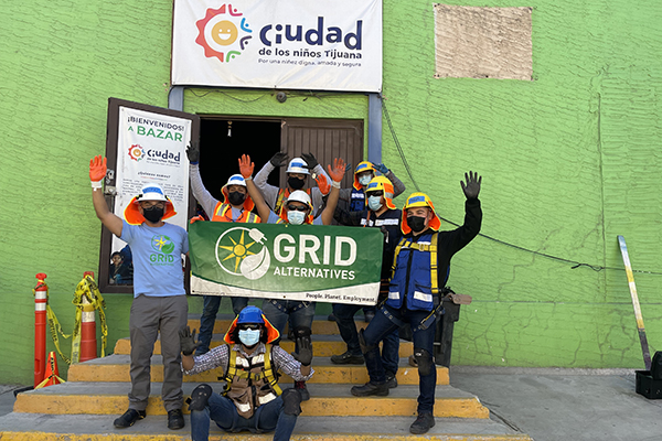 Crew at Ciudad orphanage install celebrates in front of the building