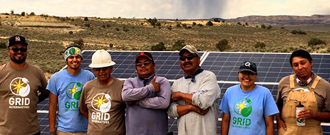 Tribal trainees pose in front of a completed ground-mount installation