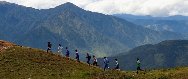 Karnali Sports Club Youth Athletes running along a ridge with mountains in the background