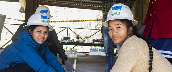 wo Nepali women from project smiling at camera as they work installation in the tower