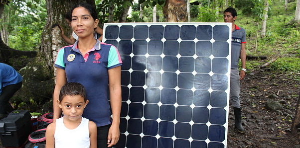 A San Jose family stands in front of their solar panel