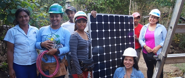 GRID Staff, Women in Solar Participants, and Local family pose with their solar panel