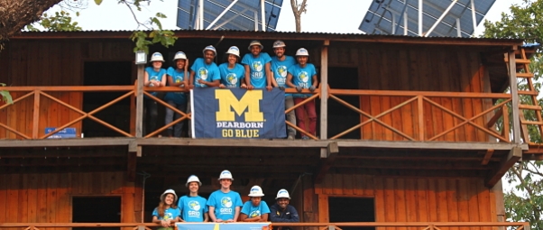 Solar Spring Breakers hang their University of Michigan banner from the observation tower at Chitwan National Park, Nepal