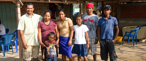 Family in Isla Zapatera in front of their home