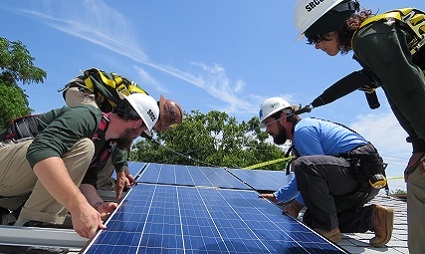 Trainees laying a panel together