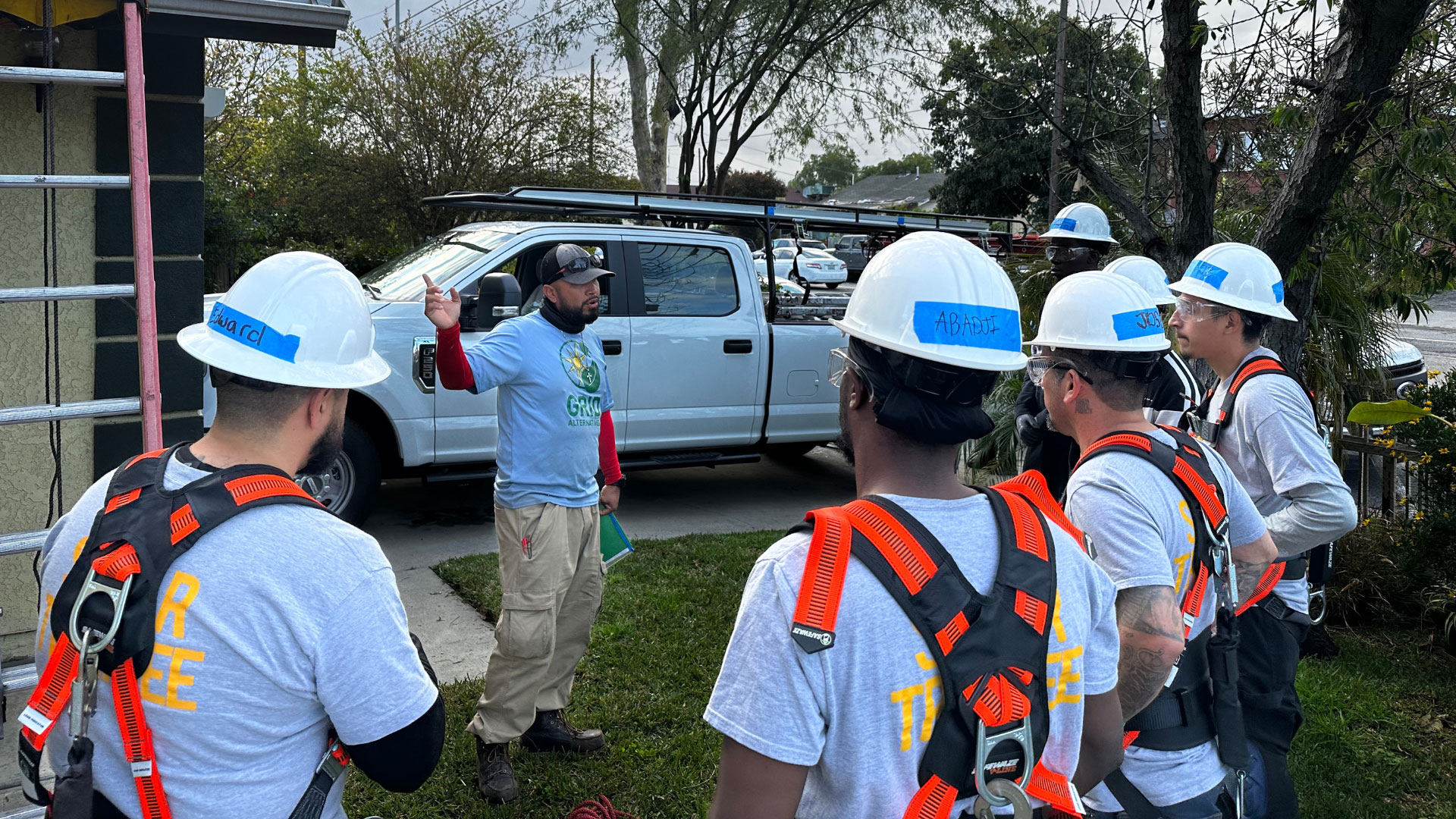 GRID GLA trainees learning at a solar install 