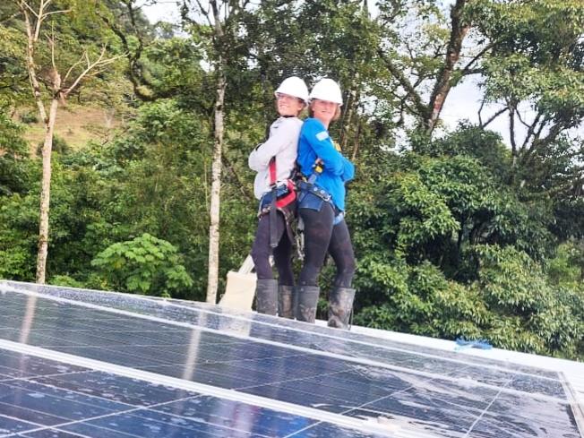 Two women installers on the roof