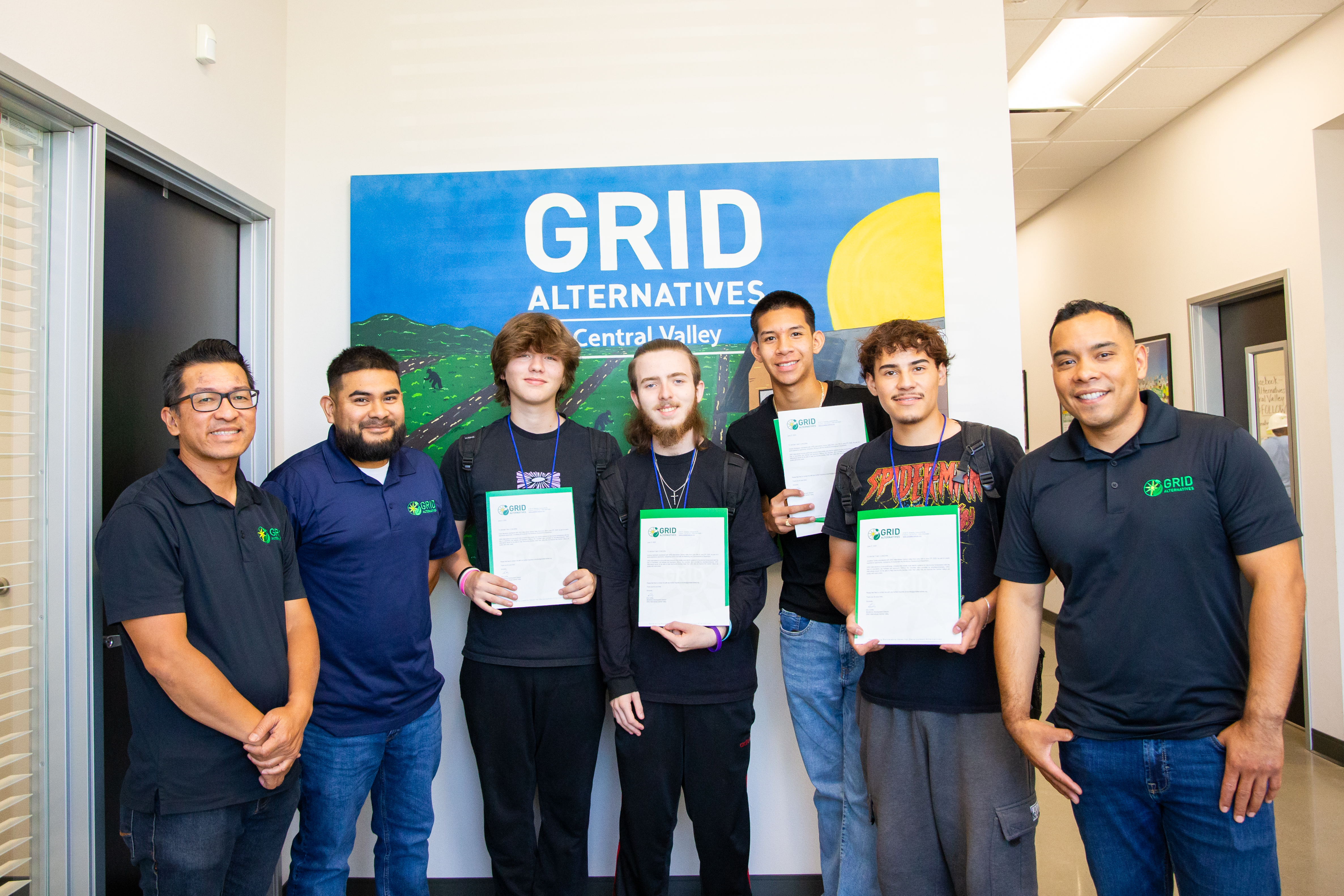four high school interns posing for photo with GRID Staff
