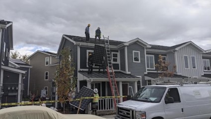 A far away view of a panel being pulled up to the roof