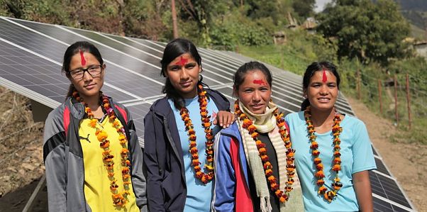 Women trainees standing next to the microgrid
