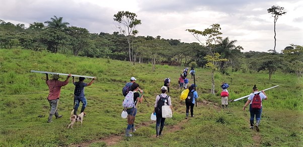 Participants carry supplies to the project site.