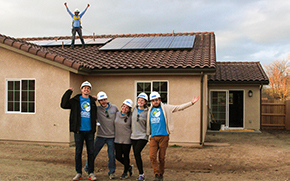 People in front of newly installed solar system