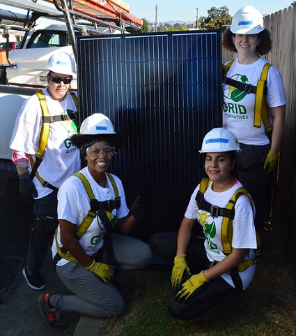 IMG: Four Women in Solar participants with a solar panel