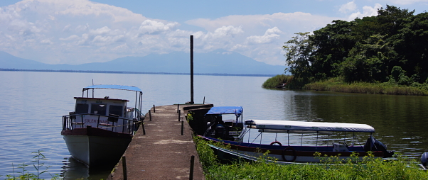 Boats floating alongside a dock on the shore of San Fernando island
