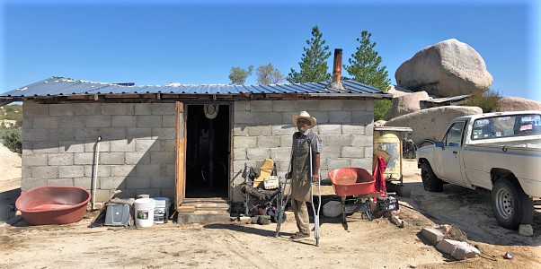 A Pai Pai man stands in front of his house.