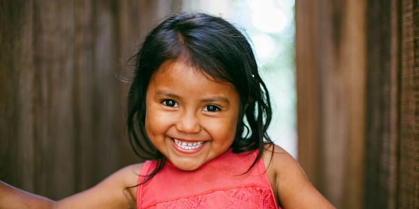A young girl smiles at the camera