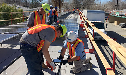 Installers working on a multifamily affordable housing structure