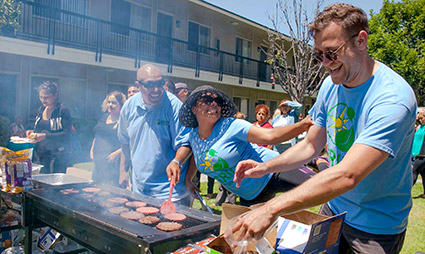 GRID staff and community members enjoying a celebratory barbecue