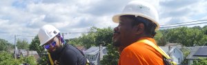 Mike G. and Naomi work on a no-cost solar installation for a homeowner in Northeast DC