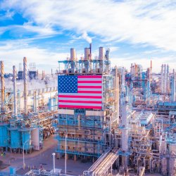 an industrial factory scene with a blue sky and an American flag 