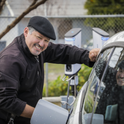 Rey Leon charging his EV at an UpliftCA event, photo by Scott Hoag