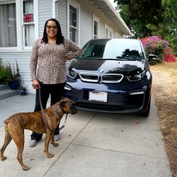 Erica Williams with her dog, Nala, in front of her EV