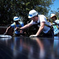 A volunteer from Accenture participates in a solar installation with GRID Mid-Atlantic.