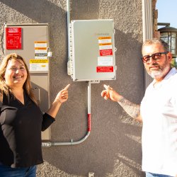 couple standing in front of a main service panel 