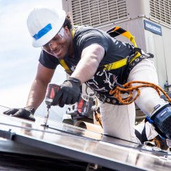 man installing solar