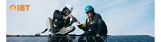 IBT Trainees building solar, man and woman with IBT orange logo
