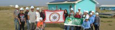 GRID staff and participants celebrate after installing solar with members of the Rosebud Sioux Tribe.