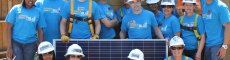 GRID volunteers with a solar panel. 