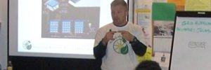 Man in a GRID shirt giving a presentation