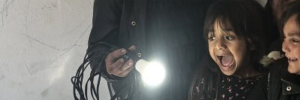 Two girls happy looking at light bulb