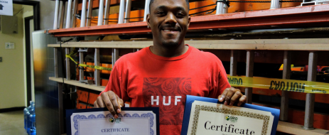 Anthony, GRID training program graduate, shows off his certificates