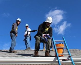 Three solar installers on the roof