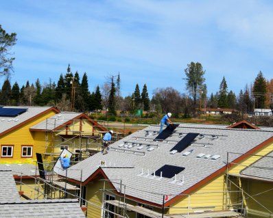 Three solar installers on the roof.