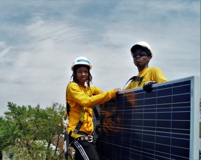 Two Solar Works DC trainees take a quick break during an installation in Washington DC.