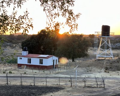 Sunset at Juntas de Neji, a rural environment with a farmhouse and a watertower