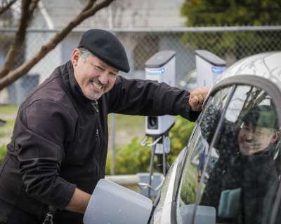 Rey Leon charging his EV at an UpliftCA event, photo by Scott Hoag
