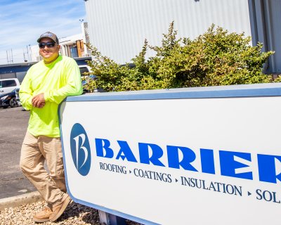 Jacob standing in front of a employer sign that says "Barrier"