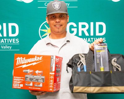 Man holding tool bag for a photo