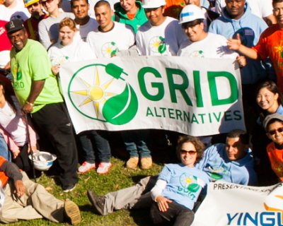 Group of GRID volunteers holding GRID sign