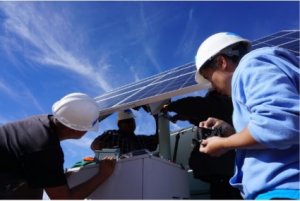 People working on solar panel