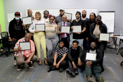 Trainees celebrate graduating from the Solar Works DC Spring 2022 cohort alongside GRID Mid-Atlantic's workforce training supervisors.