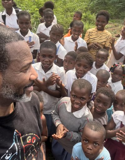 GRID Mid-Atlantic Logistics and Facilities Manager Sundiata Ramin (left) meets with local children while visiting Ghana in January 2024.